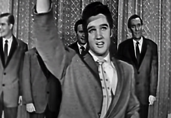 Portret Elvisa Presleyja sa prepoznatljivim frizom i odevnom kombinacijom